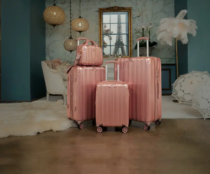 three pieces of pink luggage sitting in a room