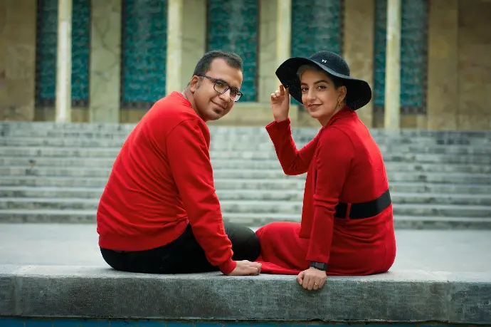 man in red and black long sleeve shirt and black hat